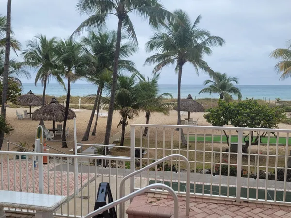 a living room with furniture a flat screen tv and a large window