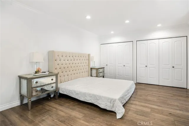 a bedroom with a bed and large window