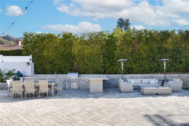 a view of a house with backyard and sitting area