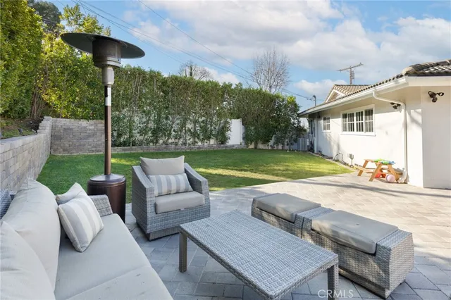 a view of a patio with table and chairs and potted plants