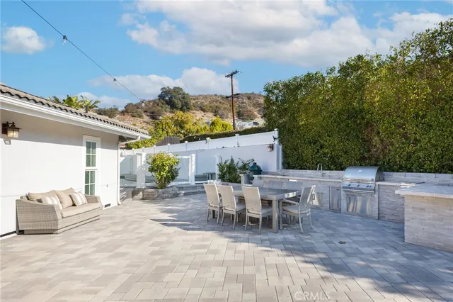 a view of a patio with table and chairs with wooden floor and fence