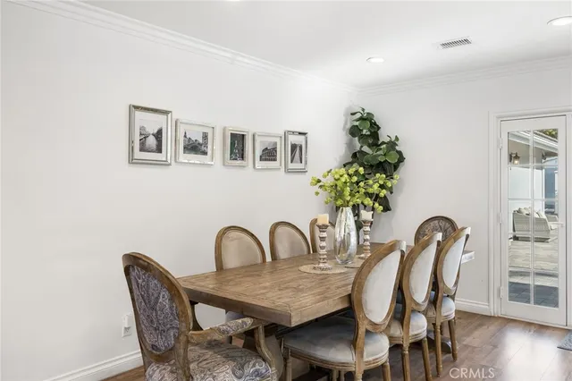 a dining room with furniture and wooden floor