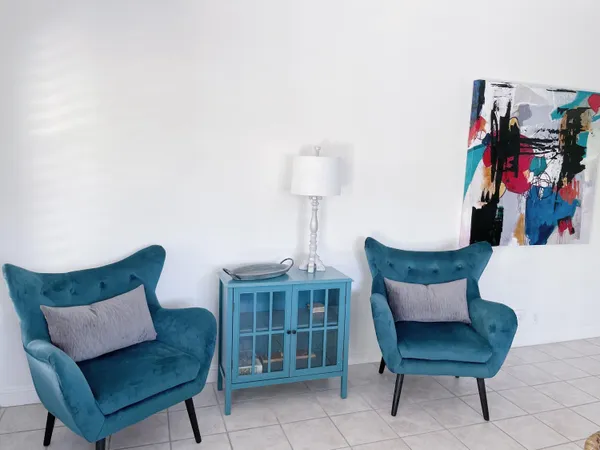 a living room with furniture and a lamp