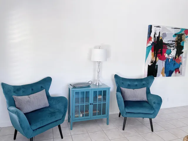 a living room with furniture and a lamp