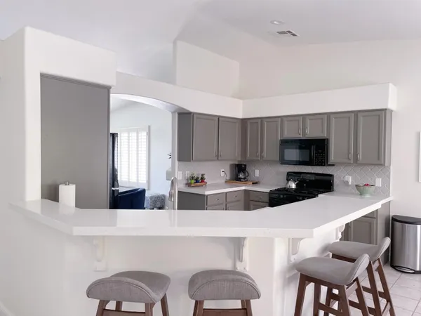a kitchen with stainless steel appliances a sink and a refrigerator
