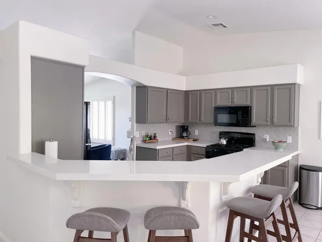 a kitchen with stainless steel appliances a sink and a refrigerator