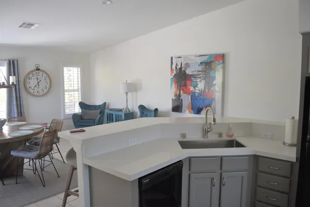a view of a kitchen area with furniture and wooden floor