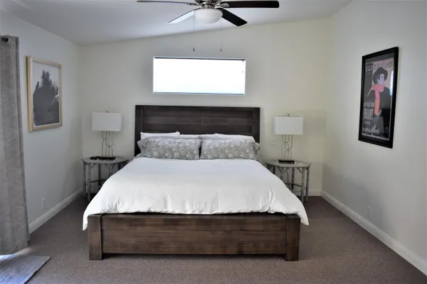 a bedroom with a bed and window