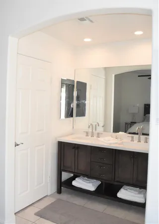 a bathroom with a double vanity sink and a mirror