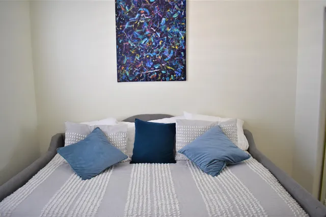 a bedroom with a bed and a couch