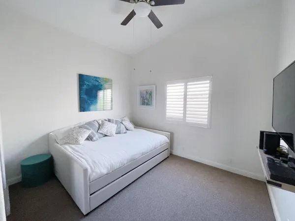 a bedroom with a bed and a tv