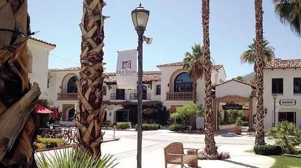 a view of a street with palm trees