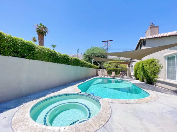 a view of a swimming pool with a yard