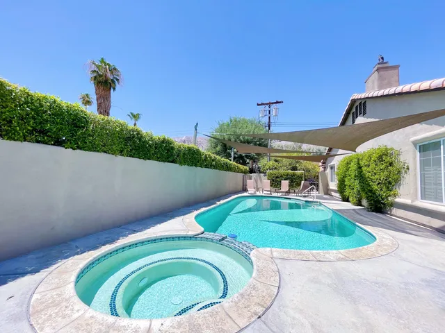 a view of a swimming pool with a yard