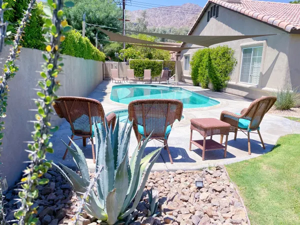 a view of a chairs and table in a patio