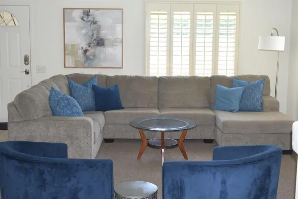 a living room with furniture and a large window