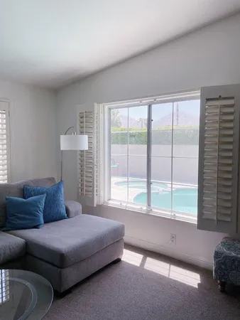 a bedroom with a bed and glass window
