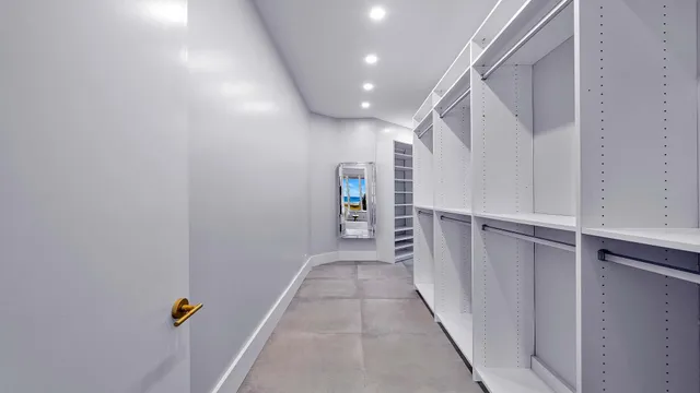 a large bedroom with a large bed and a large window