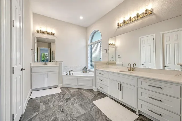 a spacious bathroom with a granite countertop sink mirror and a