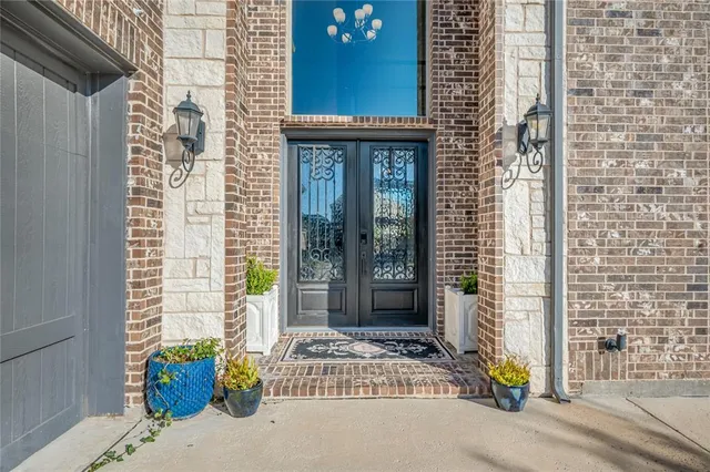 a view of a brick house with potted plants
