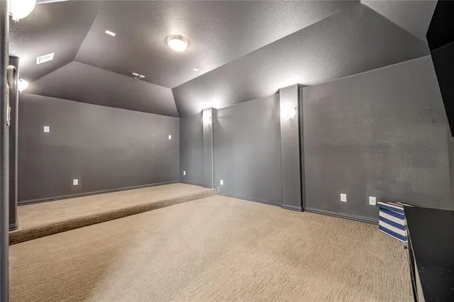 a view of a livingroom with furniture and an empty room