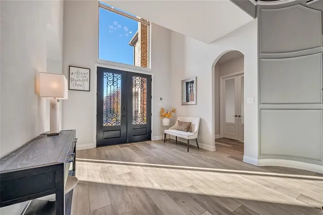 a spacious bedroom with a bed a mirror and a table