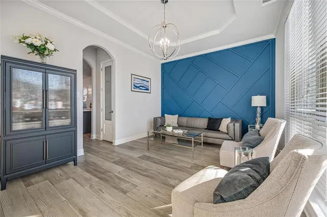 a living room with furniture and a chandelier