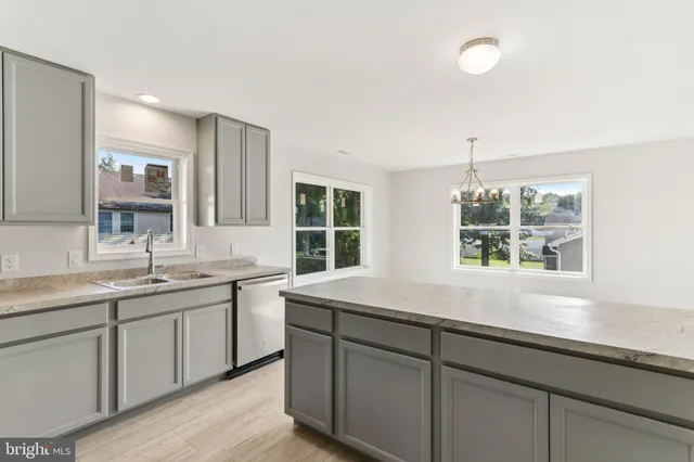 a kitchen with a sink and large window
