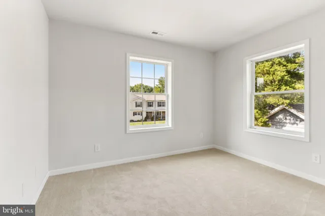 an empty room with windows and closet