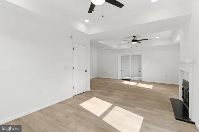 an empty room with fan and windows