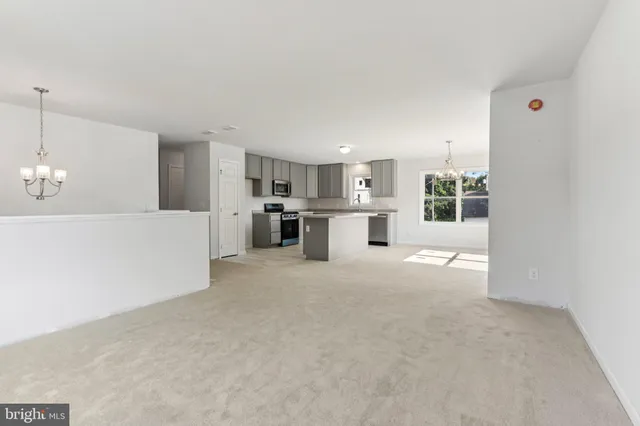 a view of a kitchen with a sink and a refrigerator