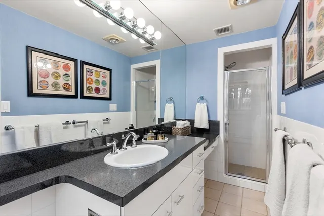 a bathroom with a sink double vanity and a mirror