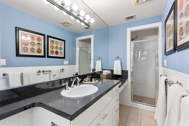 a bathroom with a sink double vanity and a mirror