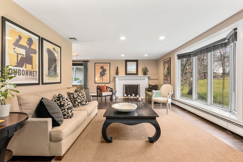 21 Gail Road Weston, MA 02493 - Photo 3 of 19 a living room with furniture a large window and a fireplace
