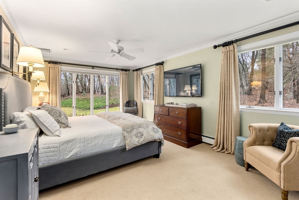 21 Gail Road Weston, MA 02493 - Photo 9 of 19 a spacious bedroom with a bed couch and a window