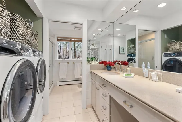 a bathroom with a sink a washer and dryer