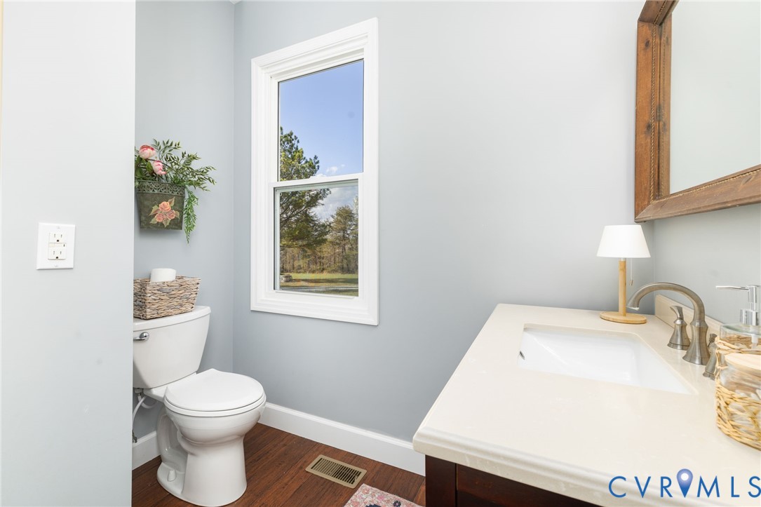 1895 Cemetery Road Chase City, VA 23924 - Photo 21 of 83 a bathroom with a sink a toilet and a mirror
