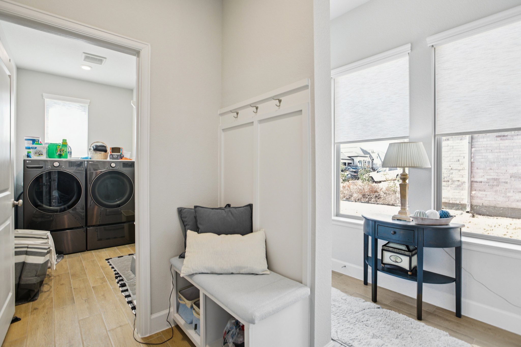 149 Plumbago Loop Bastrop, TX 78602 - Photo 18 of 33 Laundry area featuring light wood-style flooring and washing machine and clothes dryer