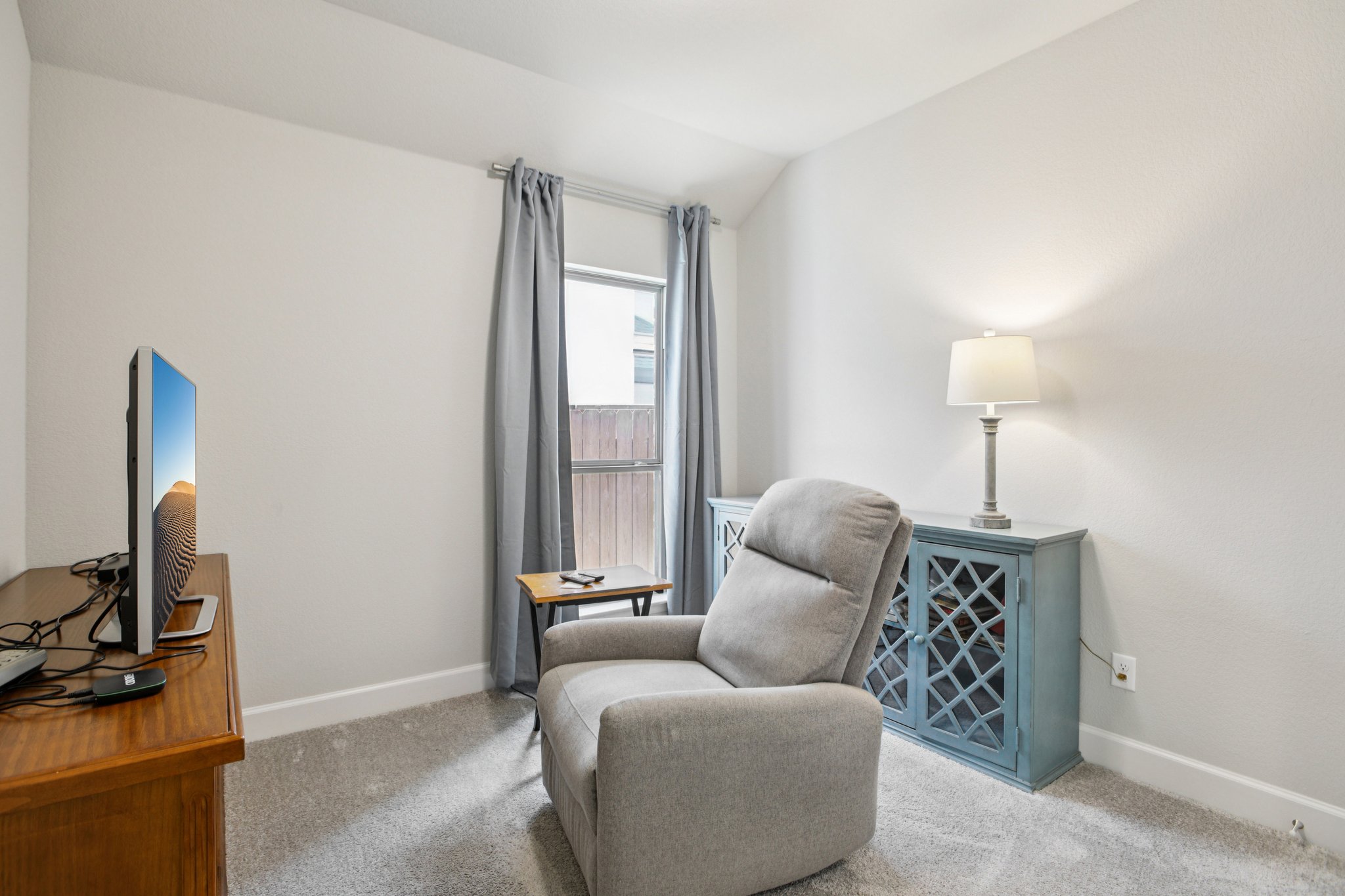 149 Plumbago Loop Bastrop, TX 78602 - Photo 19 of 33 Sitting room featuring carpet flooring and vaulted ceiling
