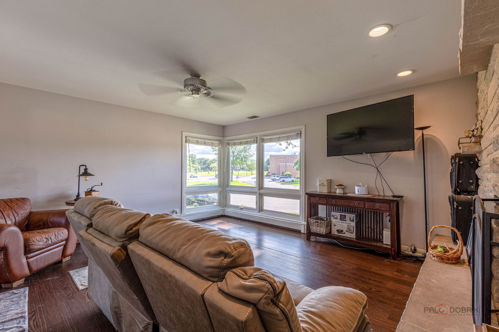 571 Nash Road Crystal Lake, IL 60014 - Photo 7 of 29 a living room with furniture a flat screen tv and a fireplace