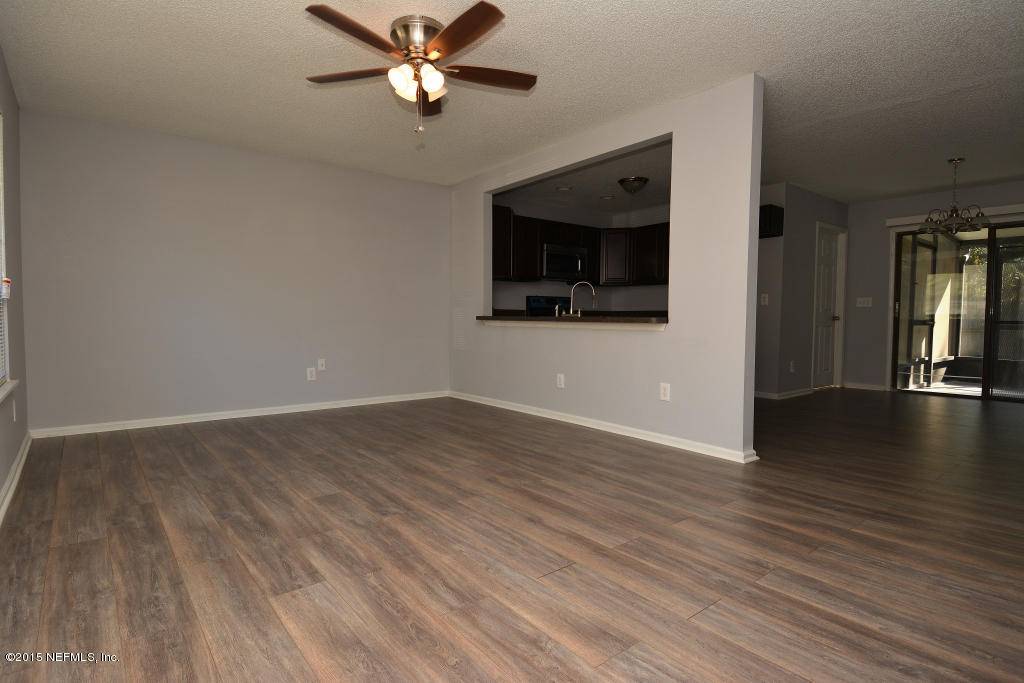 3156 Ricky Drive Jacksonville, FL 32223 - Photo 3 of 9 a view of a livingroom with wooden floor and a ceiling fan