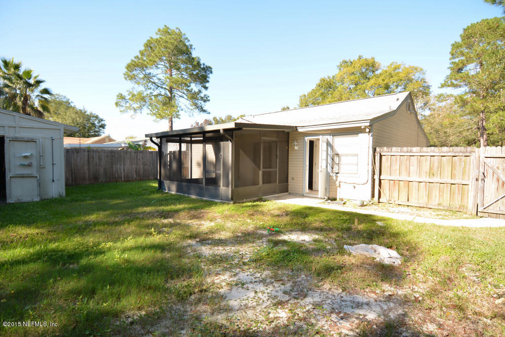 3156 Ricky Drive Jacksonville, FL 32223 - Photo 9 of 9 a backyard of a house with table and chairs and potted plants