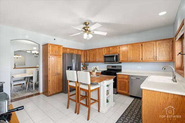 a kitchen with a table chairs refrigerator and cabinets