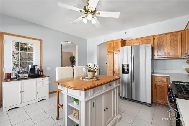 a kitchen with stainless steel appliances a stove a sink a refrigerator and cabinets