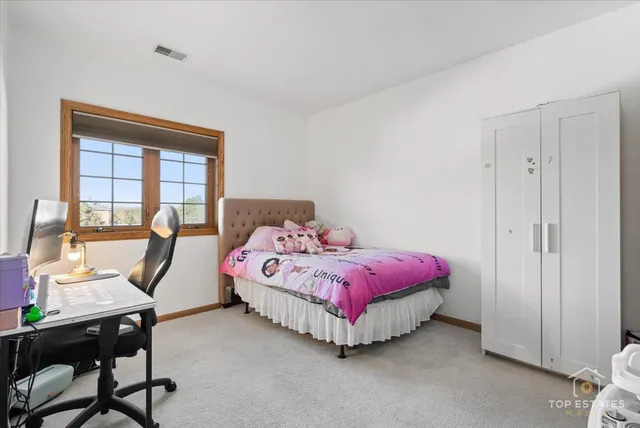 a spacious bedroom with a bed and a desk