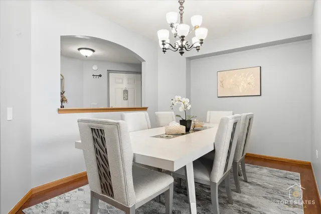 a dining room with furniture and chandelier