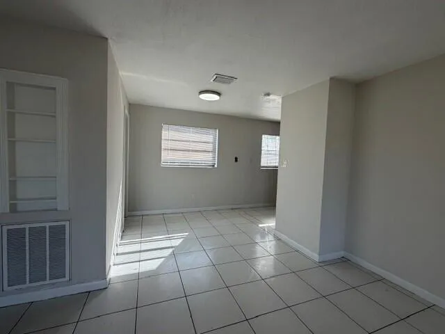 a view of an empty room with windows