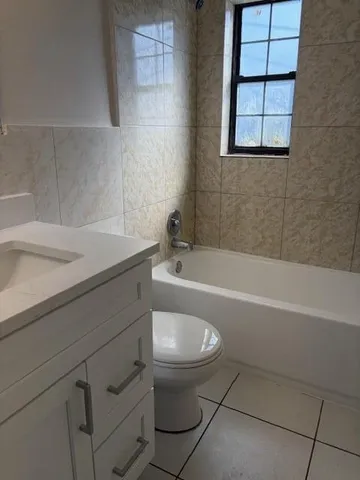 a bathroom with a sink a toilet and bathtub