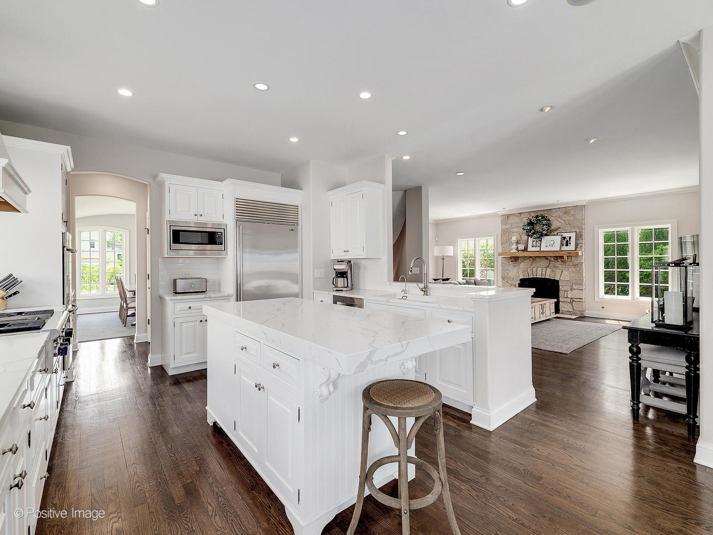 308 North County Line Road Hinsdale, IL 60521 - Photo 18 of 40 a large white kitchen with a table and chairs