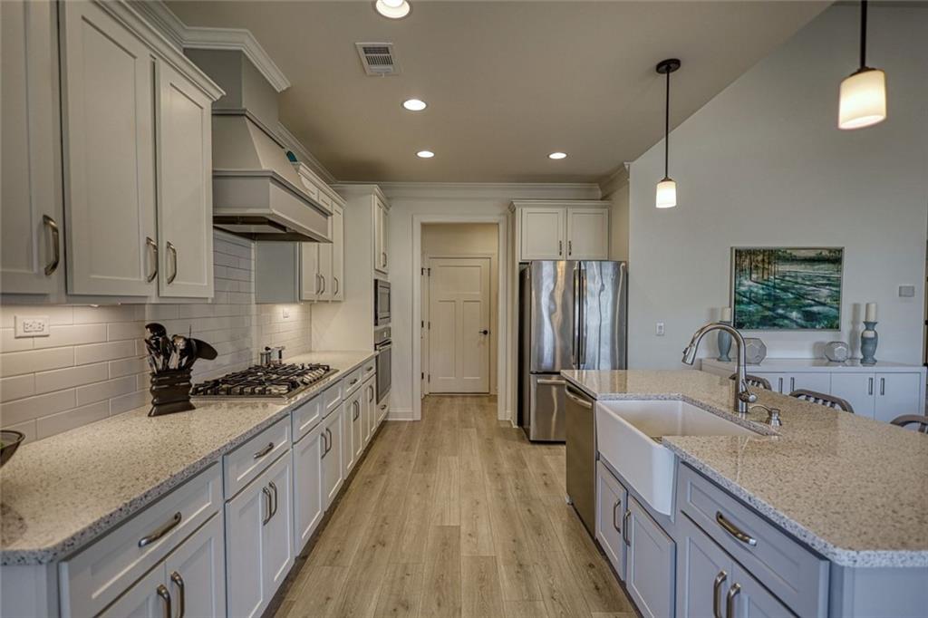 612 Haven Way Monroe, GA 30655 - Photo 12 of 44 a kitchen with stainless steel appliances a sink stove and refrigerator